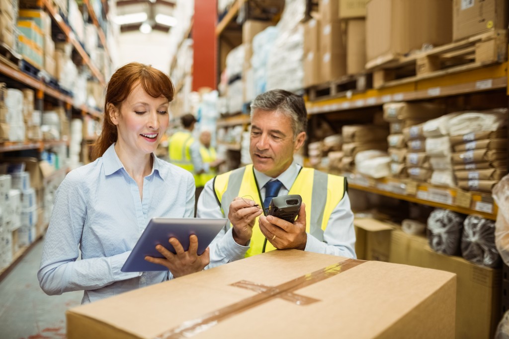 Warehouse managers looking at a tablet