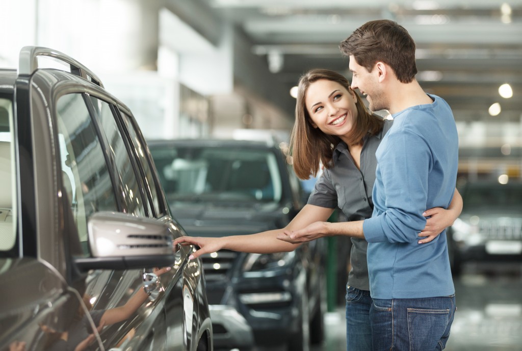 Couple choosing a car to buy