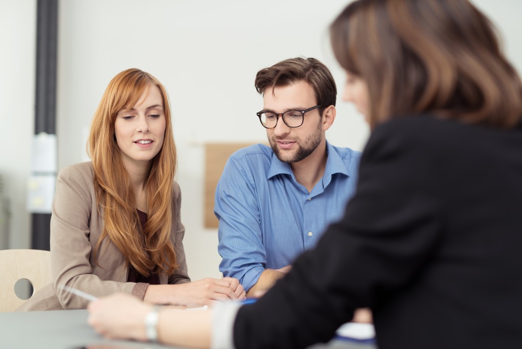 Couple talking to an agent