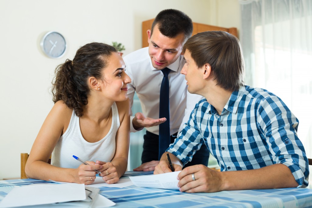 Couple consulting agent about a property