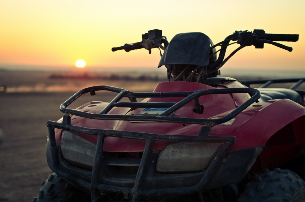 Photo of a red ATV during sunset