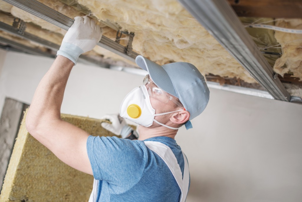 Man installing insulation