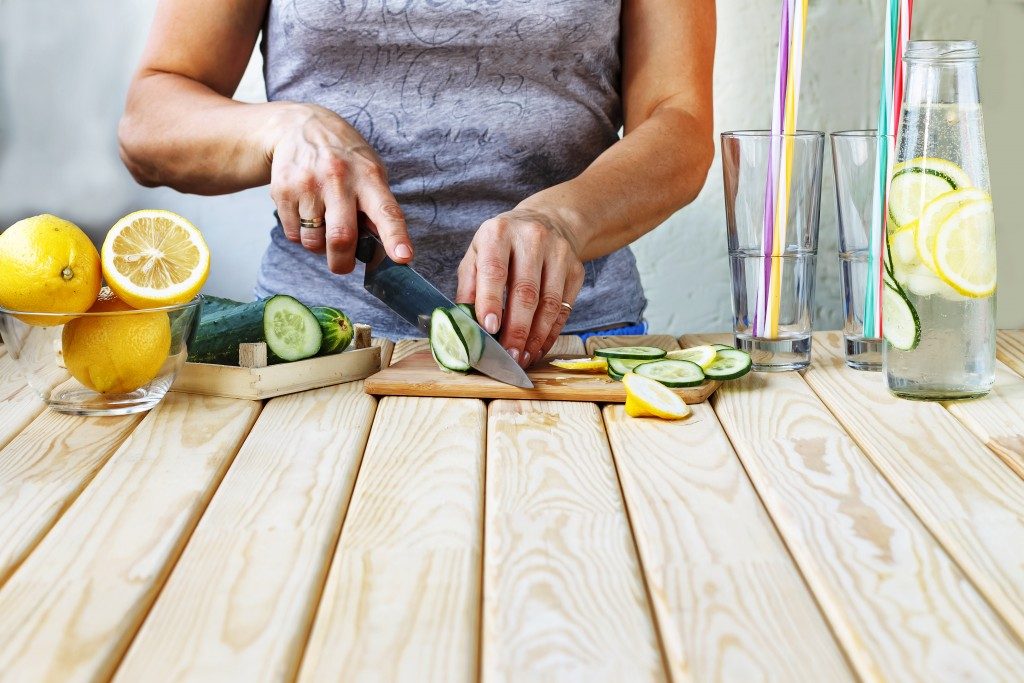 woman slicing lemon and lime