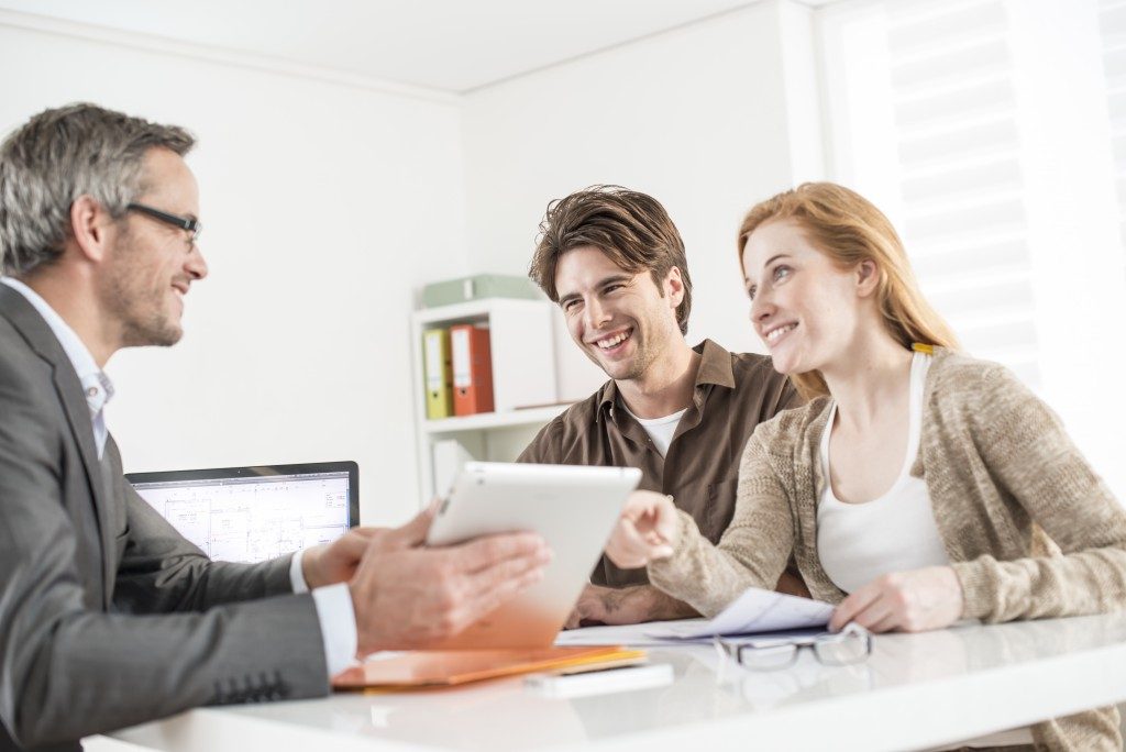 couple talking to a real estate broker