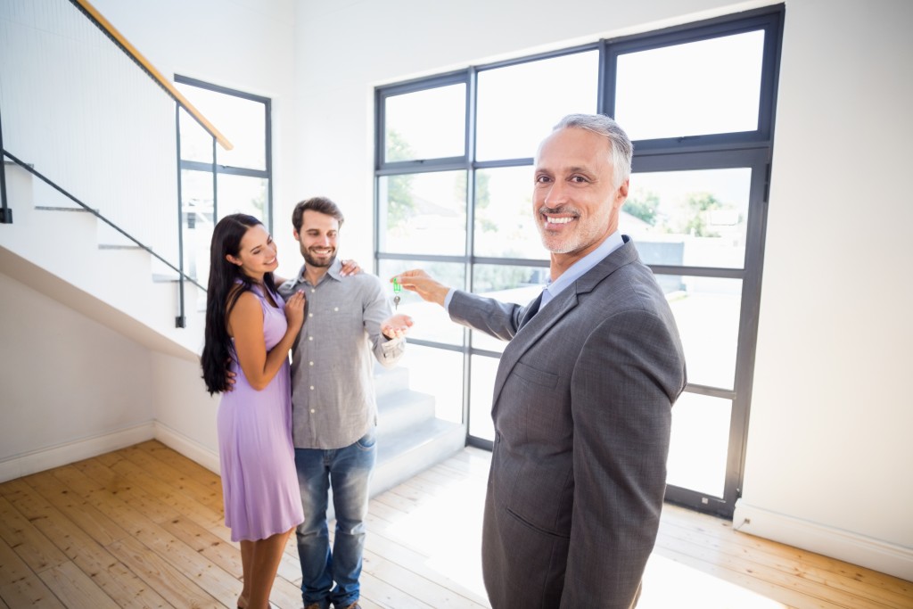 Realtor showing a house to the couple