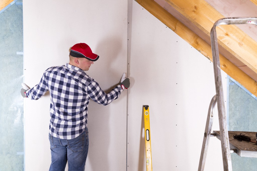 man fixing the wall