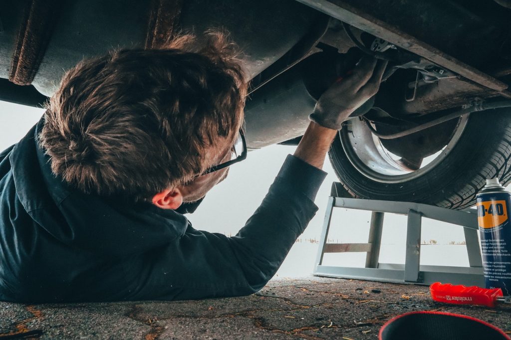 man repairing under the car