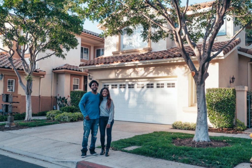 couple in front of a house