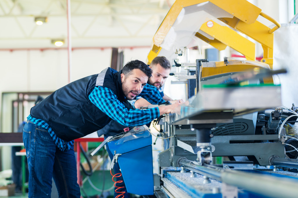 men inspecting a machine