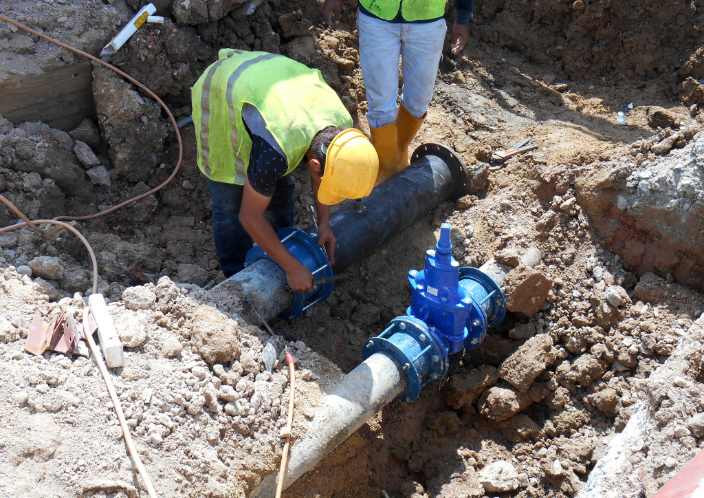 men installing plumbing