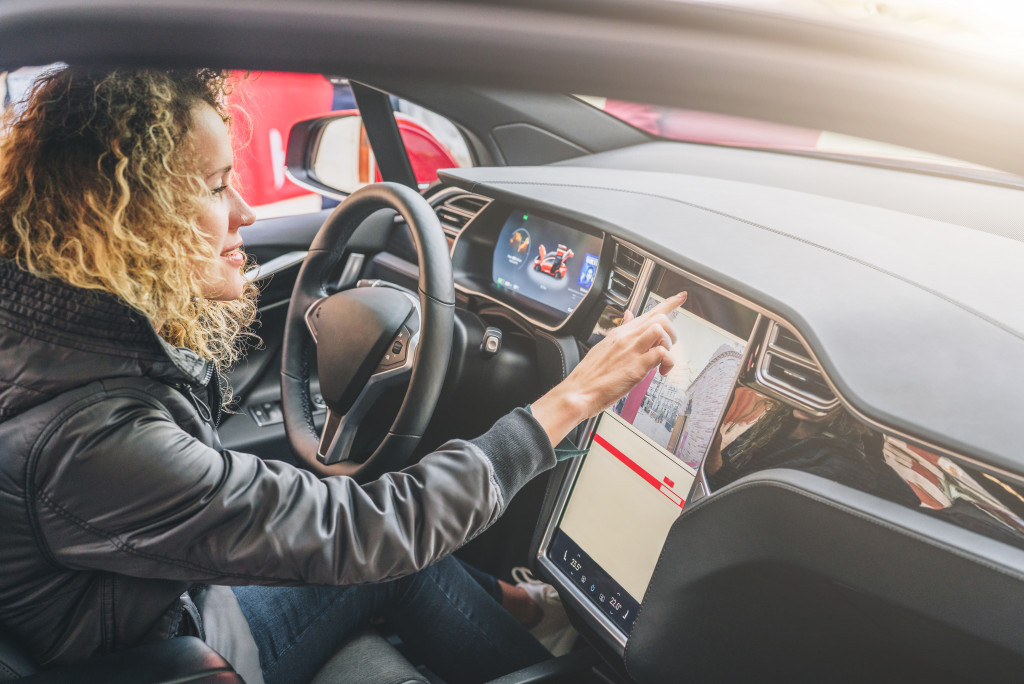 woman using her car's electronic dashboard