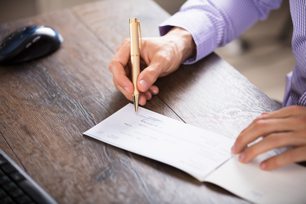 man writing a check