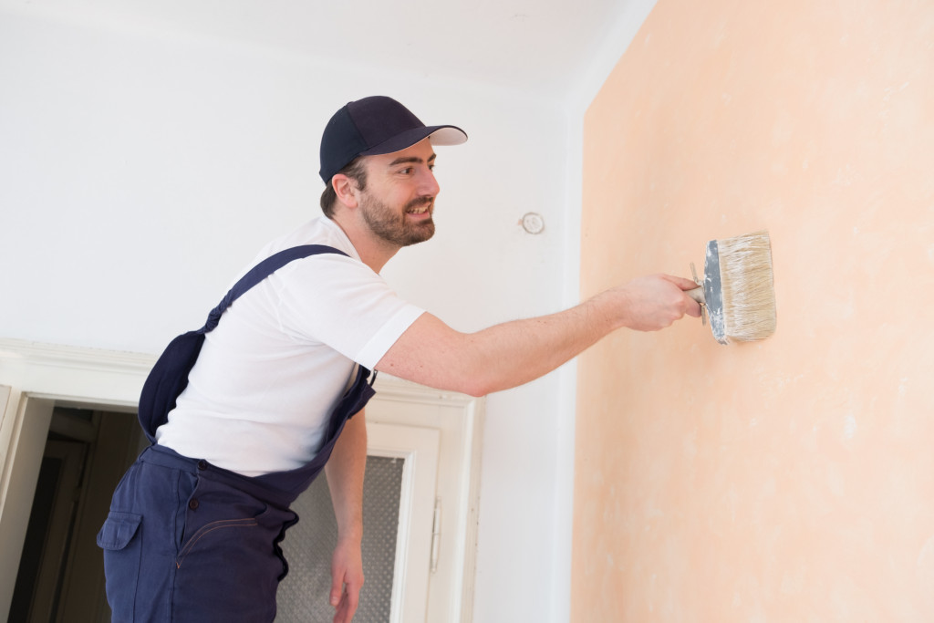 man painting a wall