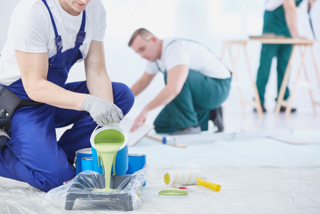 man pouring a paint 