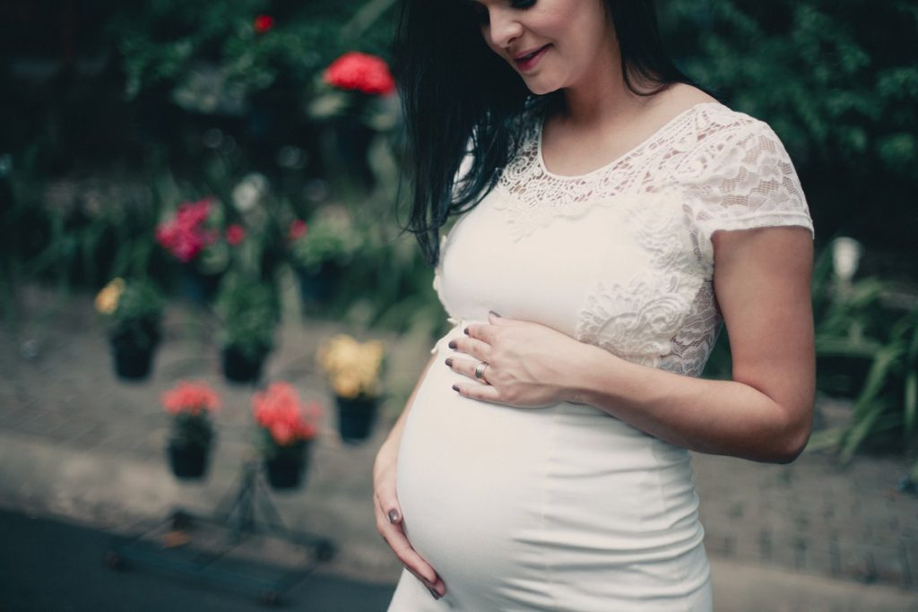 pregnant woman holding her belly