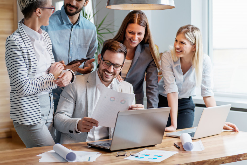 people smiling and working together