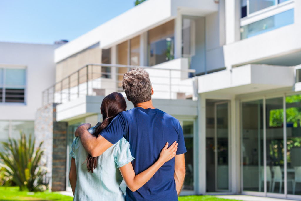 couple in front of the house