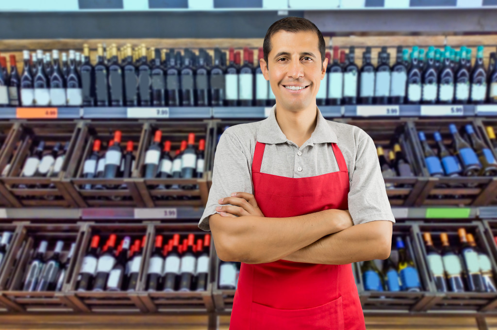 store owner in front of his wine