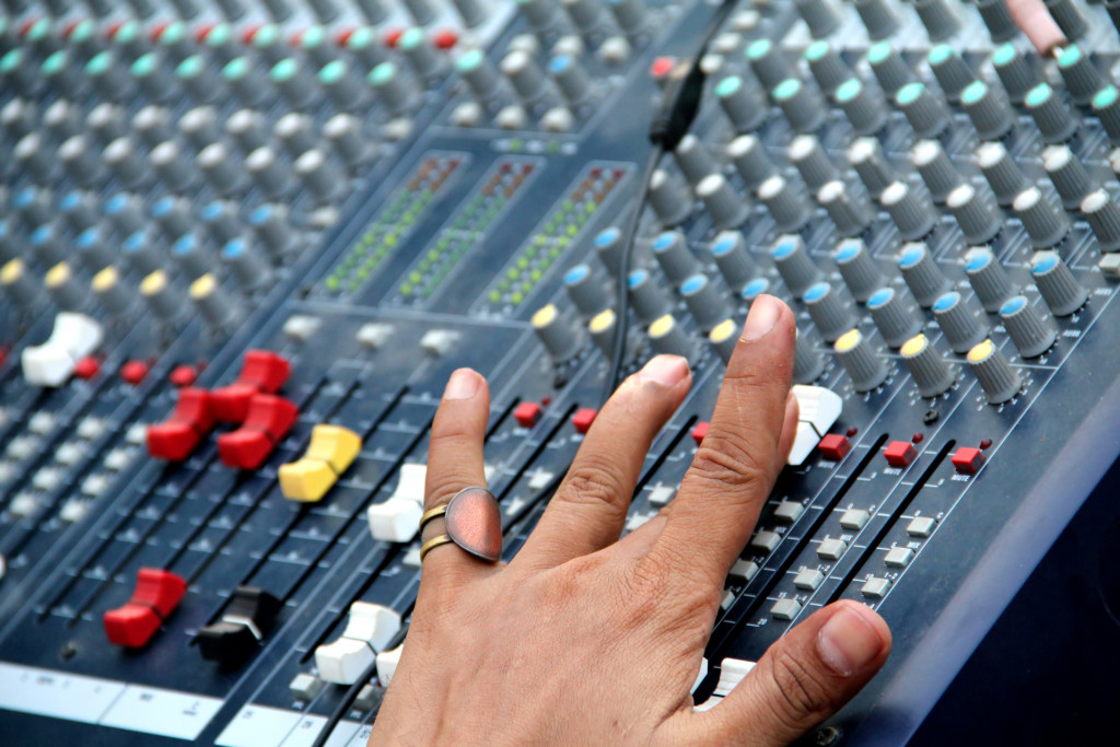 An audio sound mixer during a guitar performance