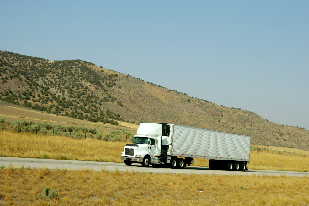 Semi truck going up hill on interstate highway