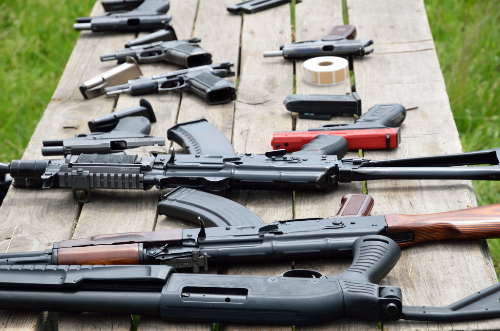 guns laid out on a wooden table