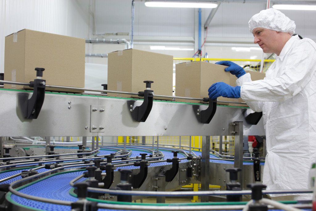 Old man working in a warehouse on conveyer belt 