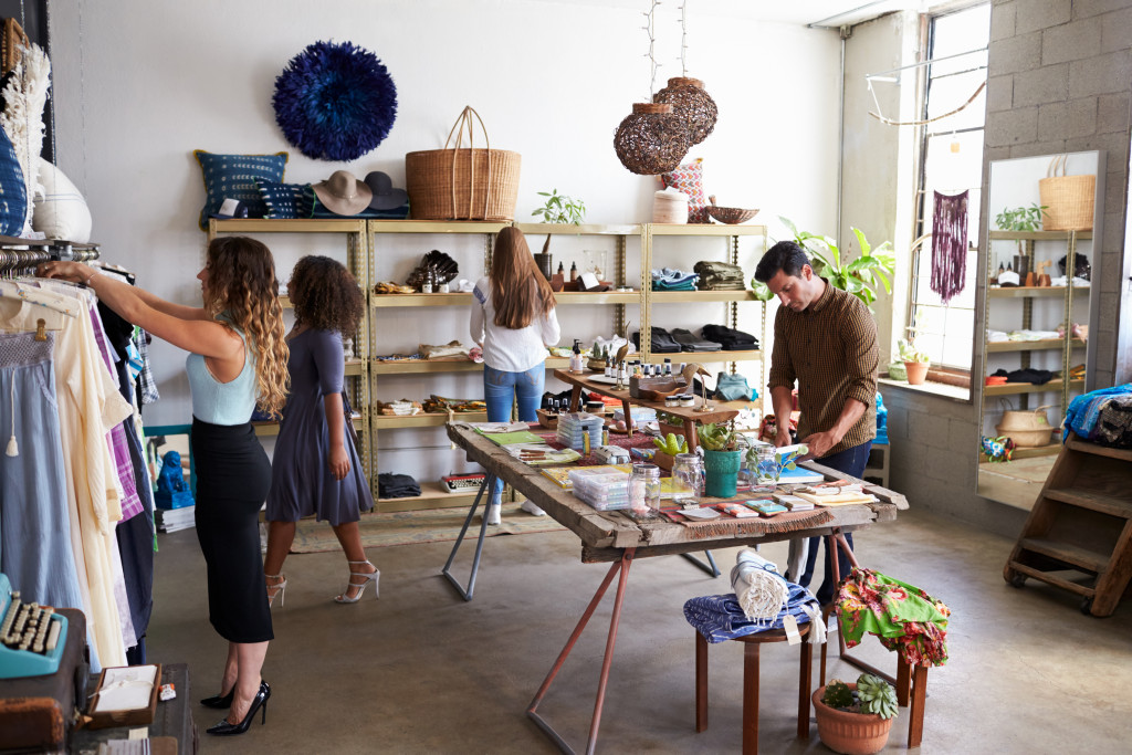 a clothing store with several people looking around