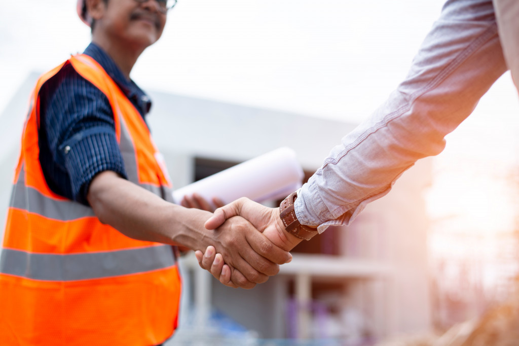 Client and contractor shaking hands on project