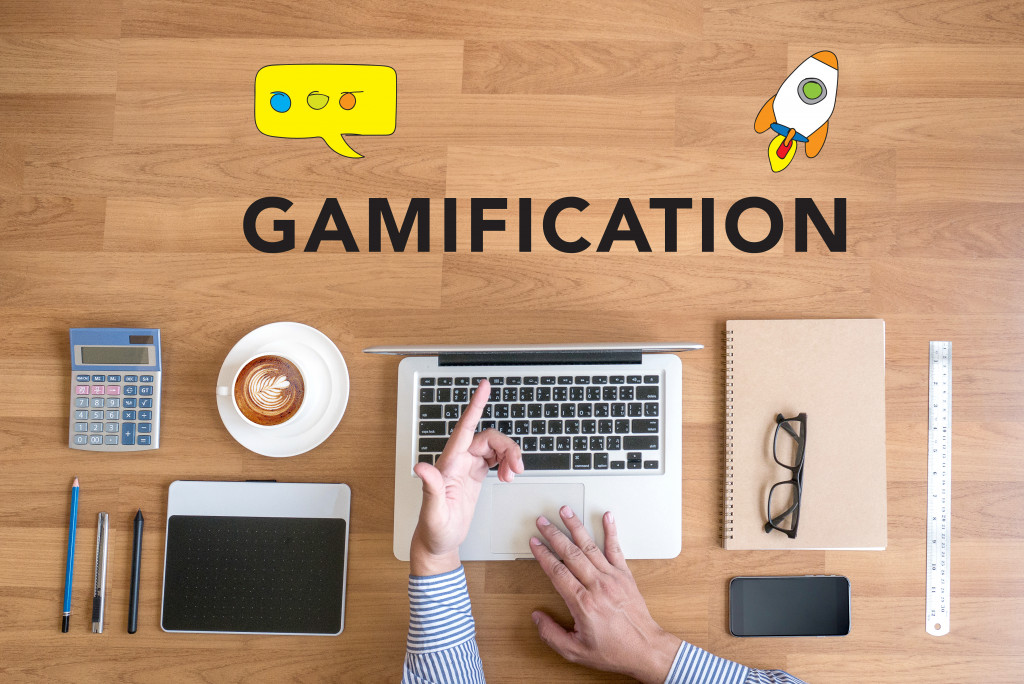 A person working on an organized desk with Gamification written on it