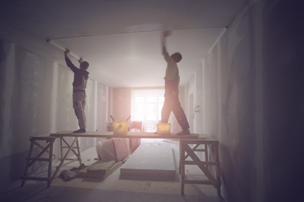 Construction workers putting new wallpaper