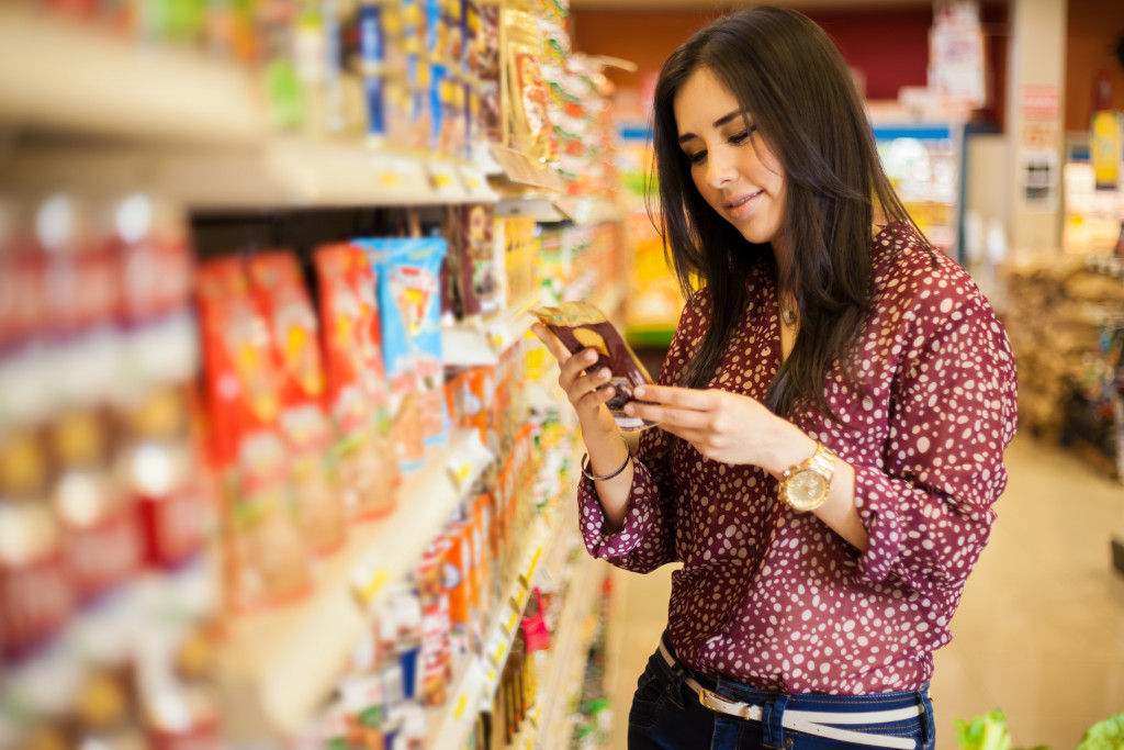 A woman examining a product label at the store