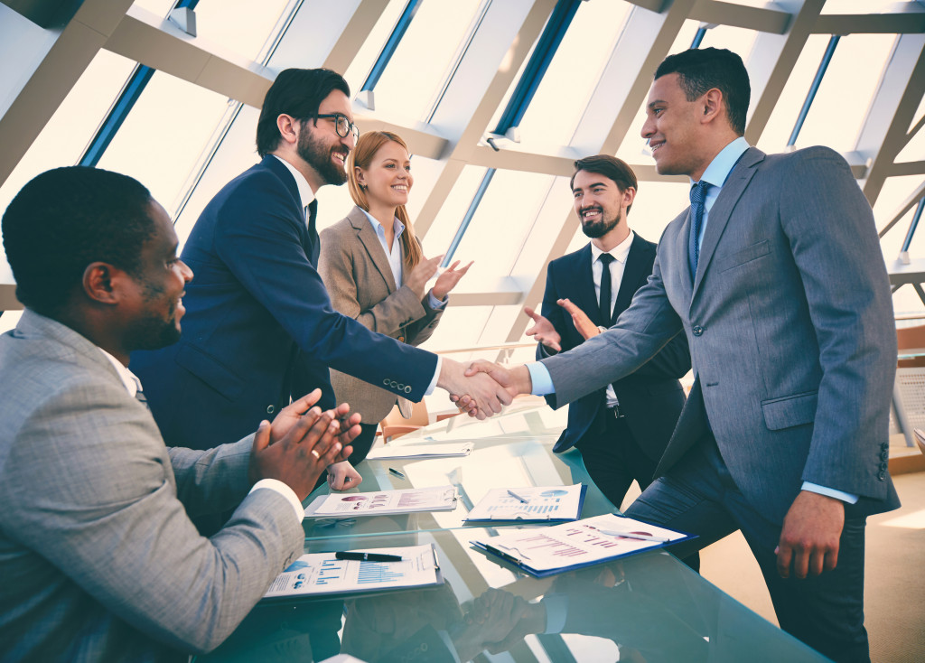 Business partners handshaking after signing contract