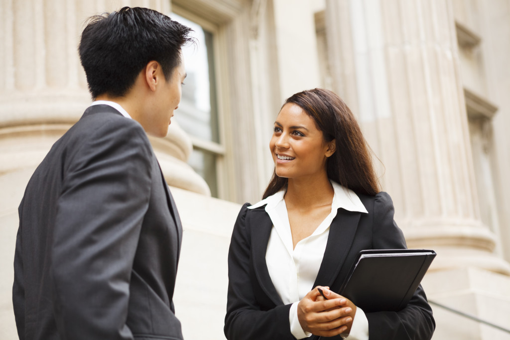 Two business owners talking outside a building