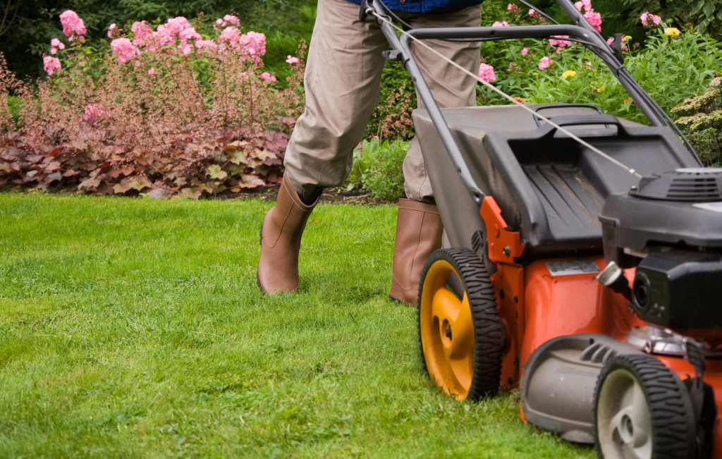 A lawn care servicer mowing grass