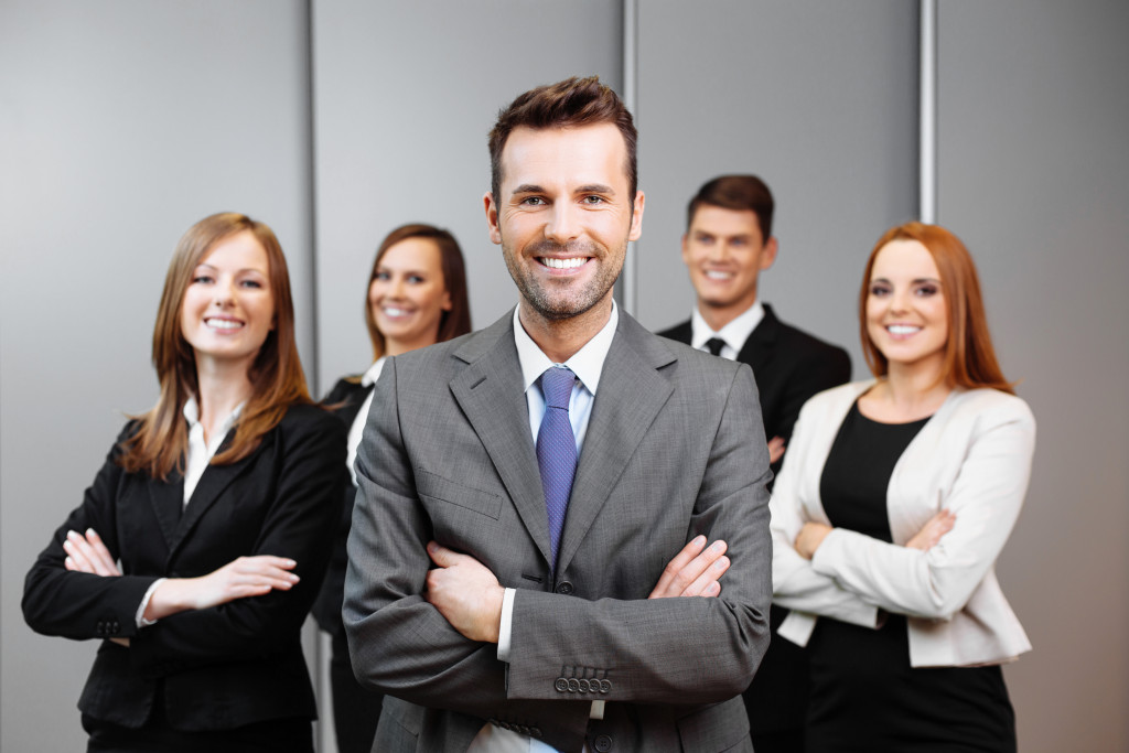 a businessman with team members at the background