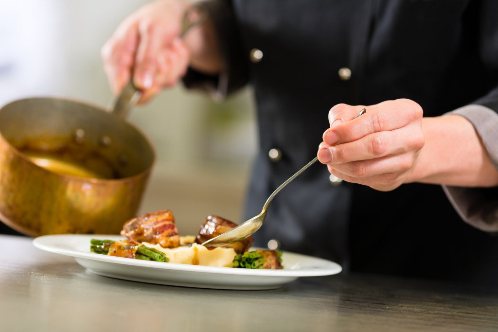 a chef adding glaze to a food