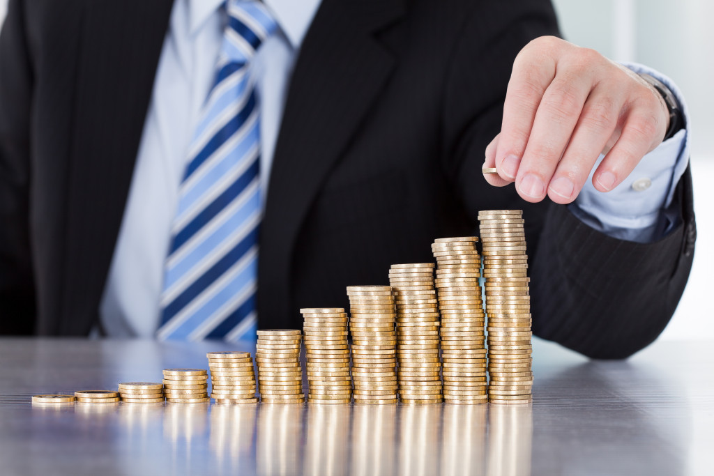 A businessman stacking coins