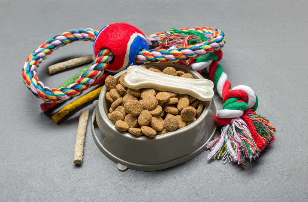 Dog food, treats, toys, and bowl