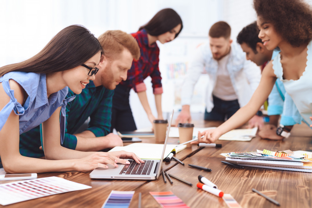 Employees working together to complete a project in an office.