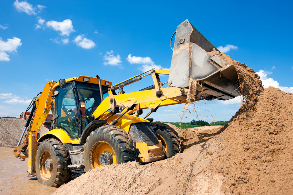 a construction tractor getting land