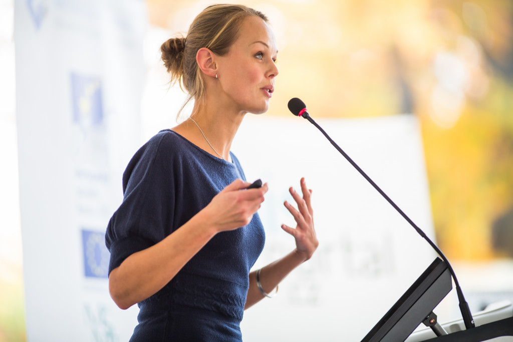 pretty businesswoman speaking in a conference or meeting