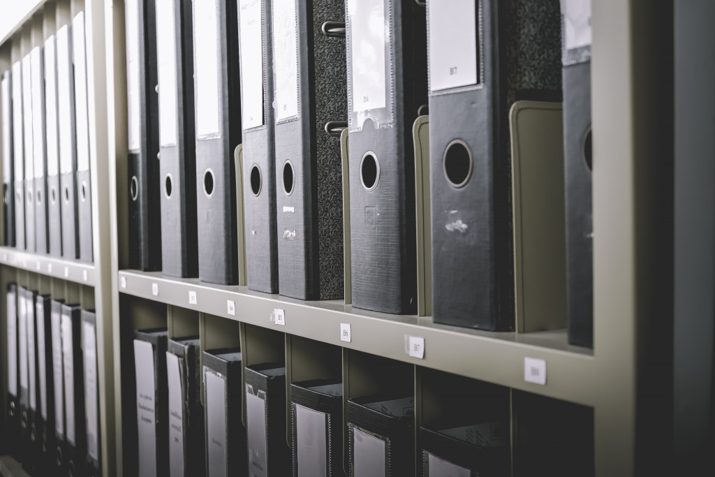 Neatly filed binders in office shelves