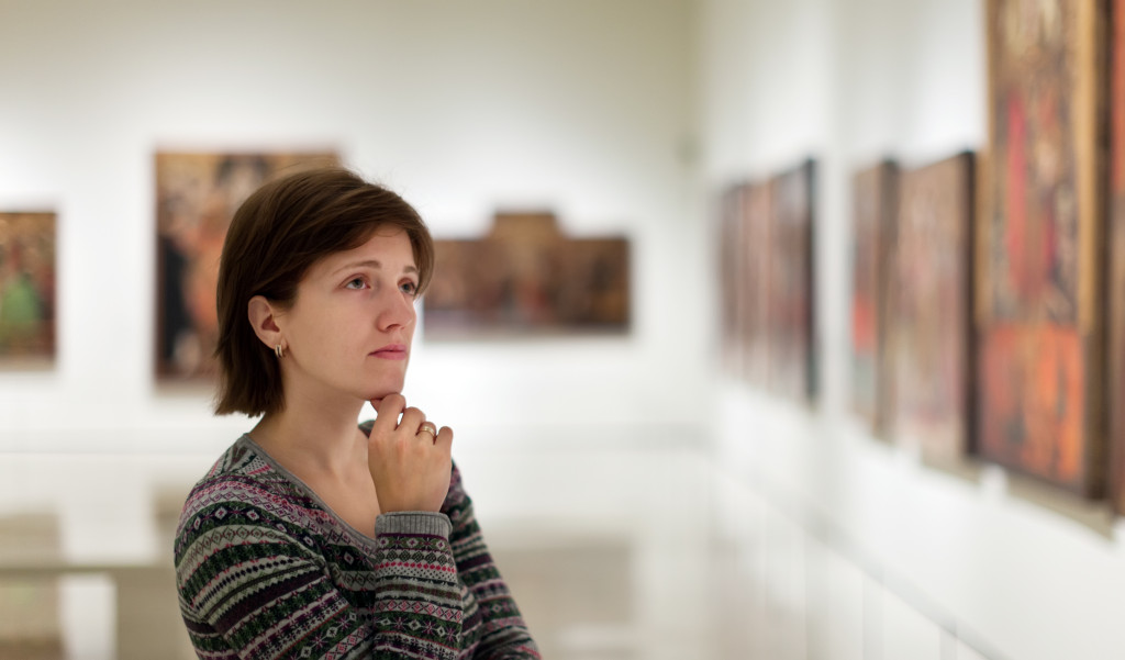 A woman looking at artworks in a museum