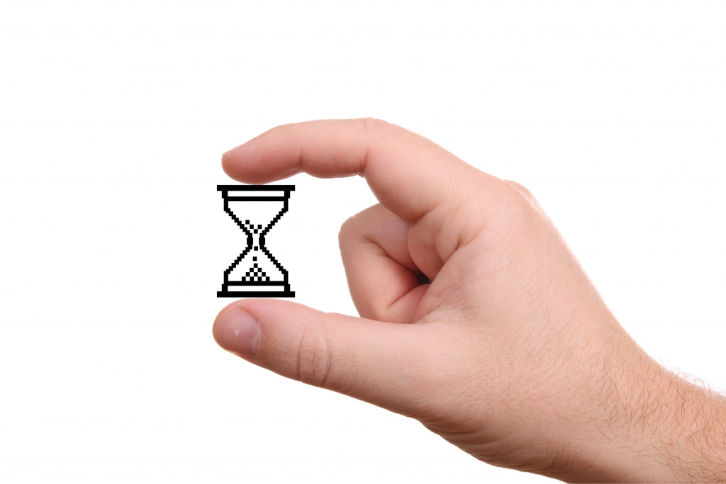 A hand holding a digital hourglass