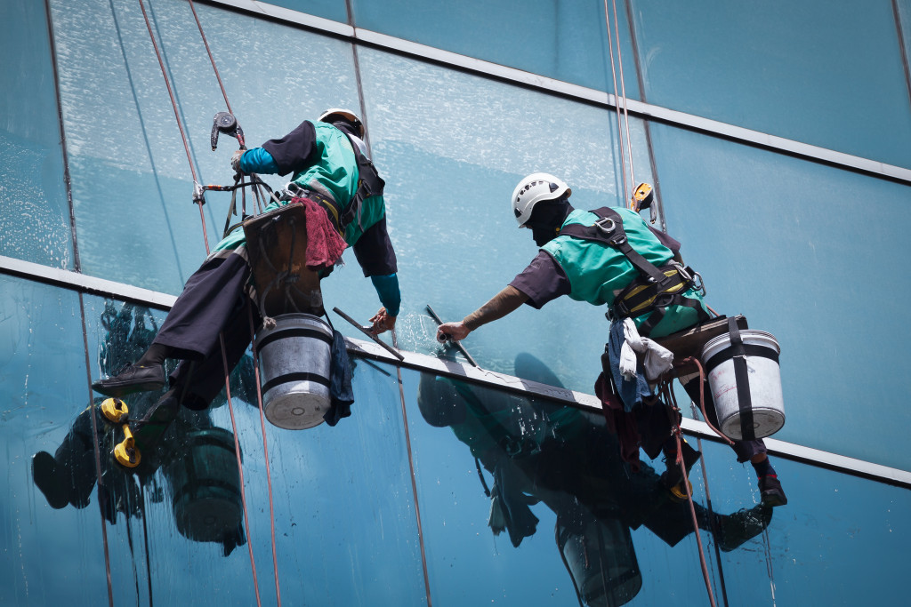 Window cleaners, cleaning glass windows of a high-rise building