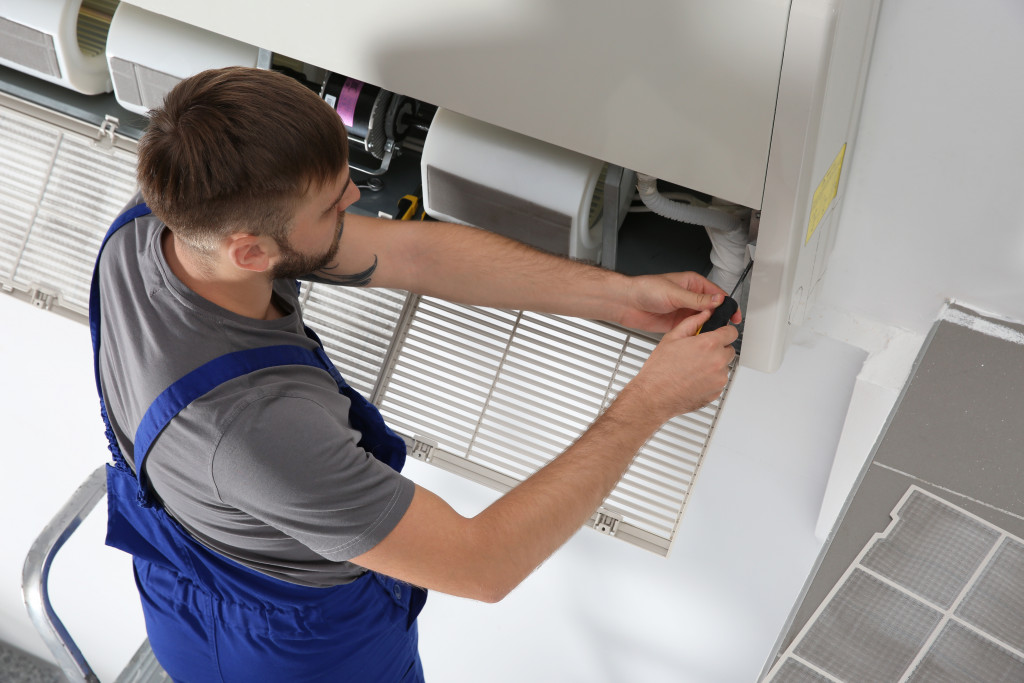 Technician checking an office air conditioning unit.