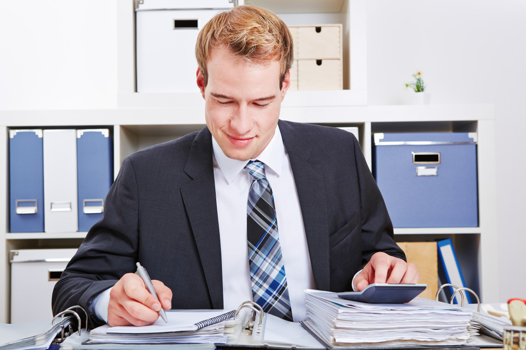 a man making computations in an office