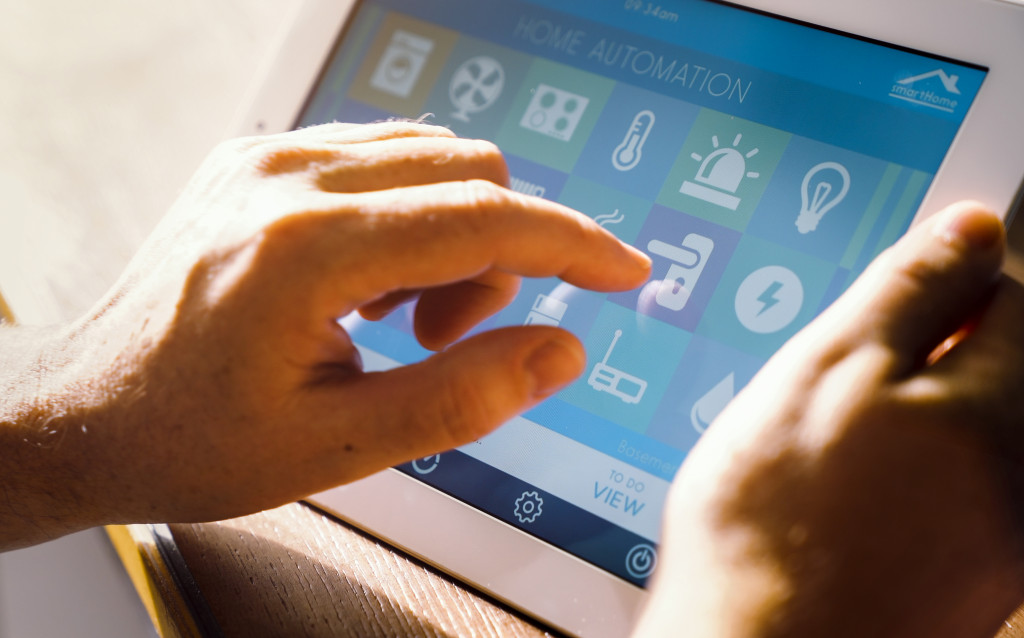 a man using a tablet to control a smart home