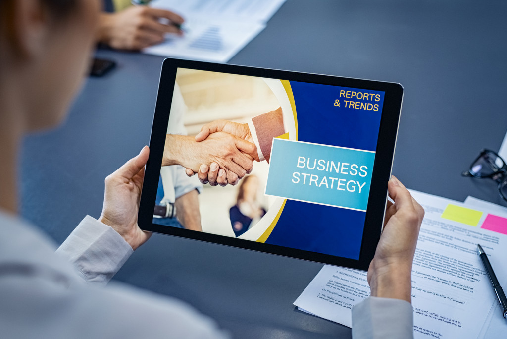 a businessman reviewing a business strategy report on a tablet