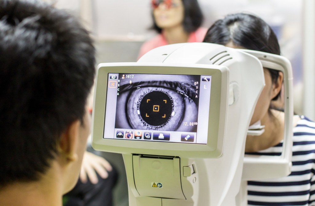 An optometrist examining the eye of a patient